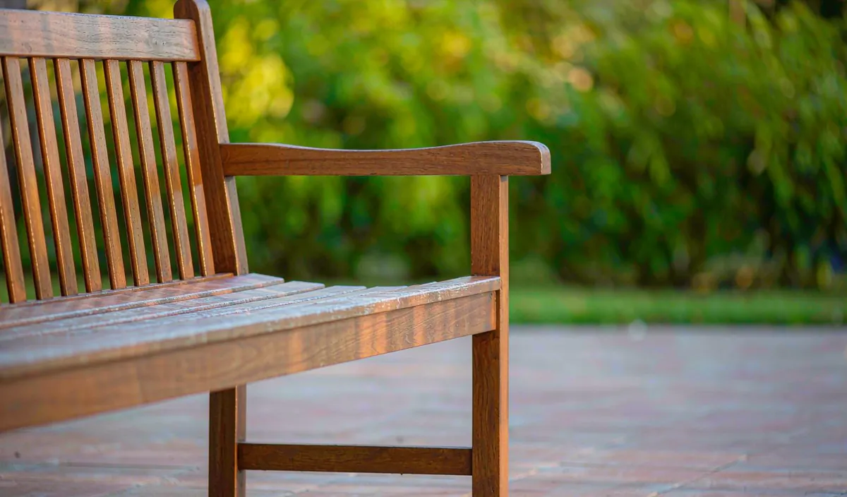 Side profile of a wooden patio bench showing seat depth and height proportions
